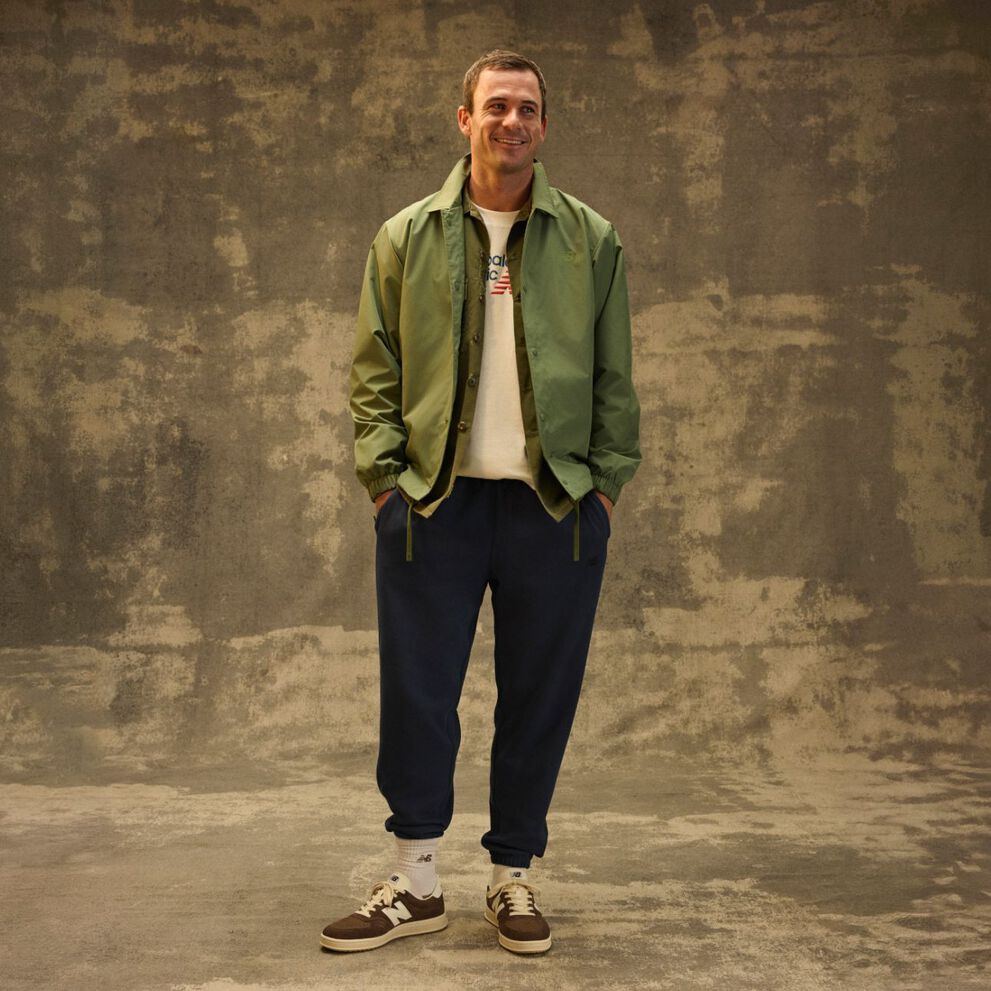 Tommy Paul standing in front of a grungy studio backdrop. 